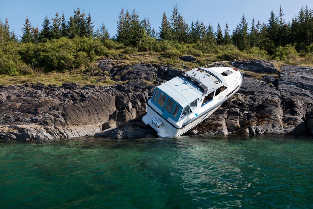 boat crashed on the rocky shore of a lake
